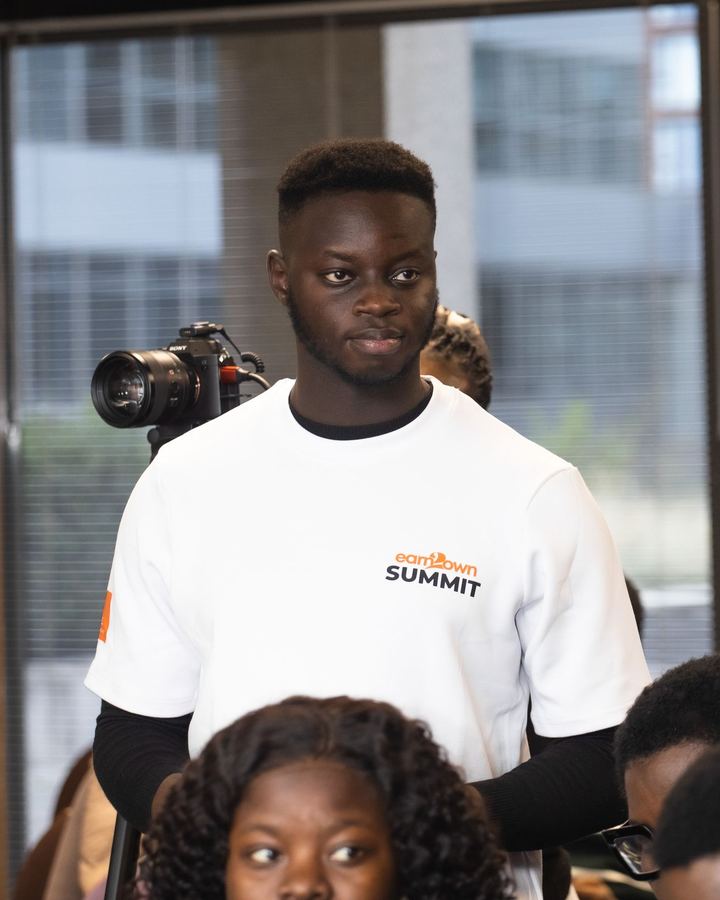 A volunteer on camera at the Earn2Own Summit